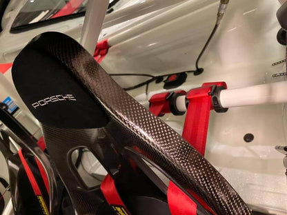 Harness retaining rings behind seats